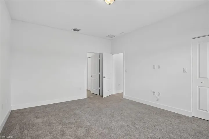 Unfurnished room with carpet and baseboards