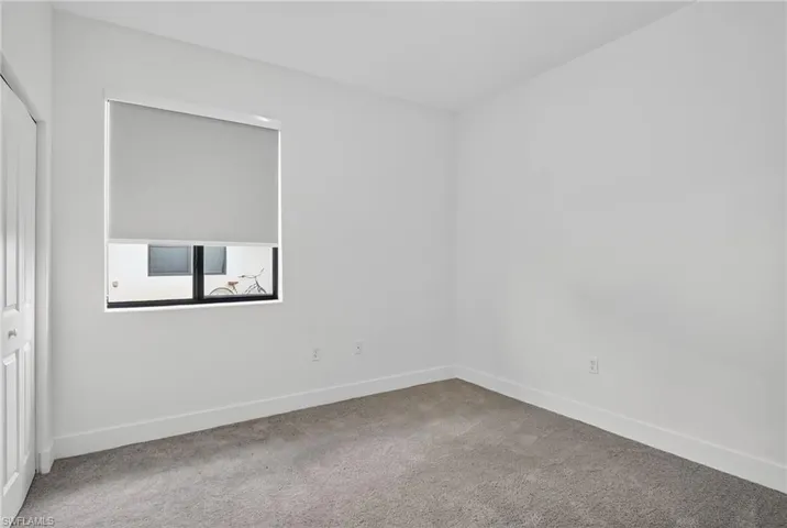 Carpeted spare room with baseboards