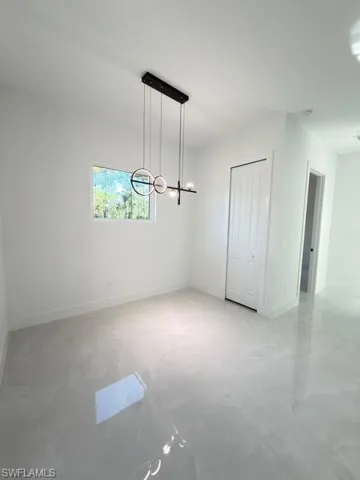 Unfurnished dining area featuring baseboards