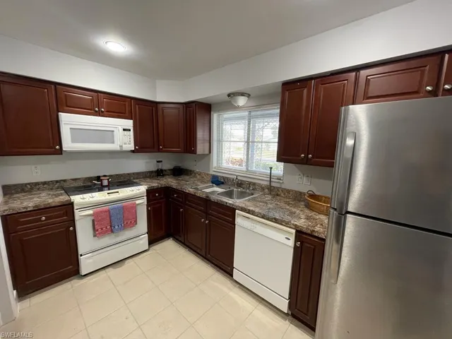 Kitchen featuring sink and white appliances
