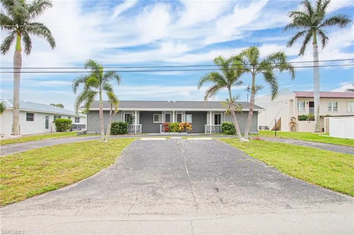 Single story home featuring a front lawn