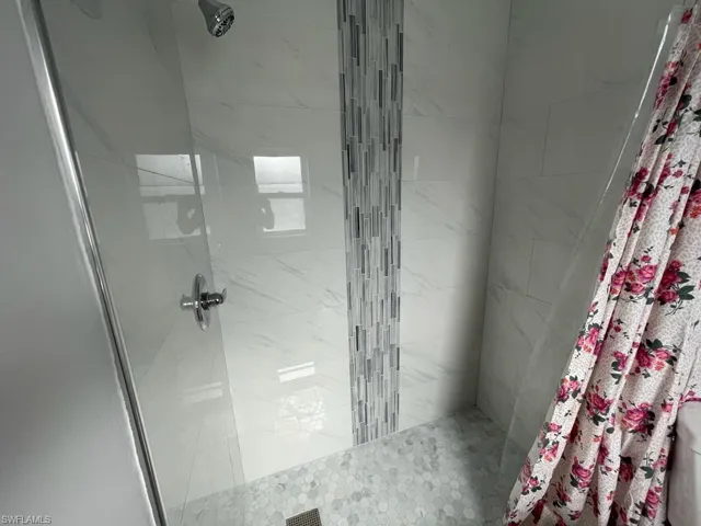 Bathroom featuring curtained shower