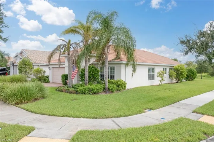 View of side of property with a garage and a yard
