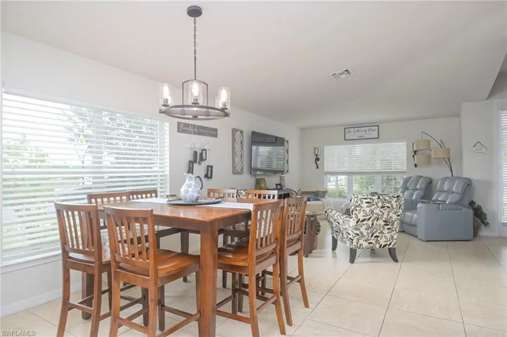 Tiled dining area with an inviting chandelier