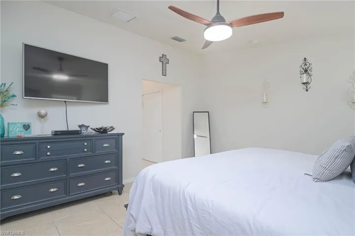 Tiled bedroom with ceiling fan