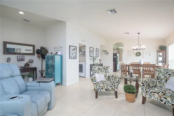 Tiled living room with a chandelier