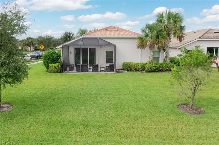 Rear view of property featuring a patio and a yard