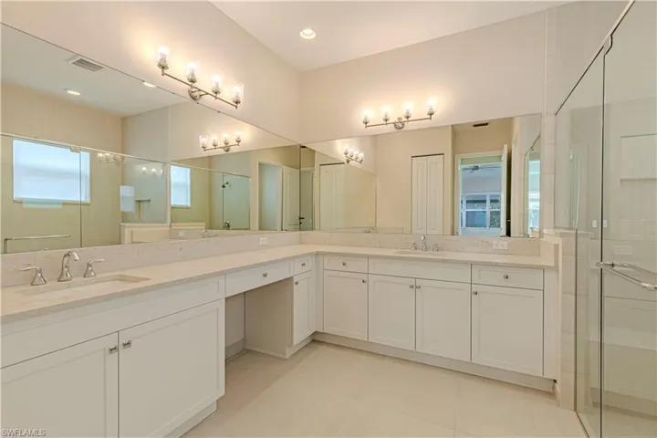 Bathroom with vanity, tile patterned floors, and walk in shower
