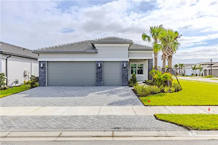 View of front of home with a front lawn and a garage