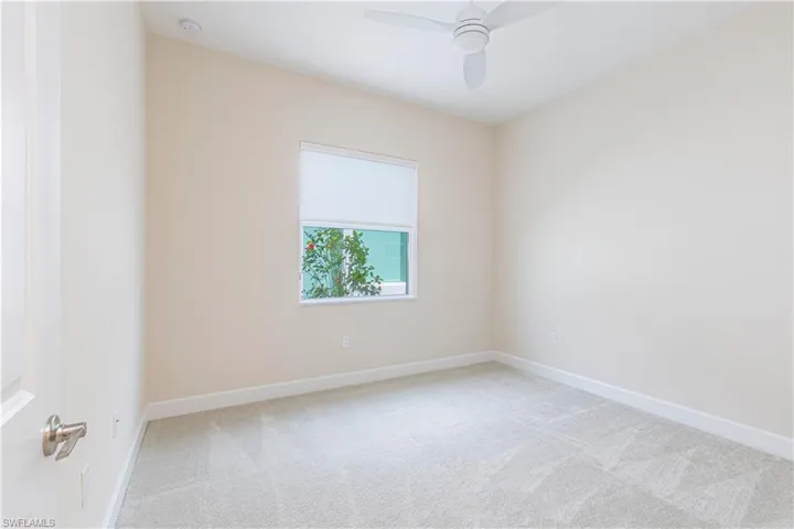 Unfurnished room with light carpet and ceiling fan