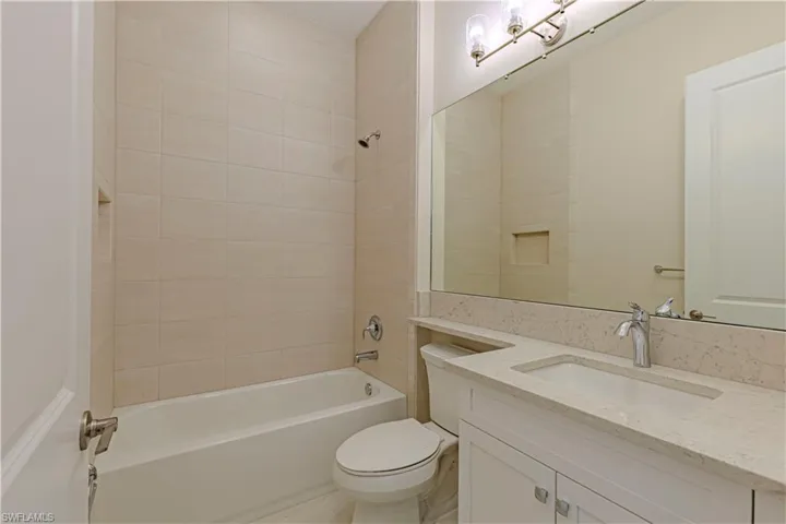 Full bathroom with vanity, toilet, and tiled shower / bath