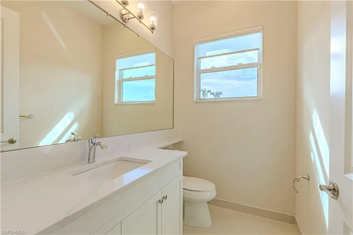 Bathroom featuring vanity, toilet, and tile patterned flooring