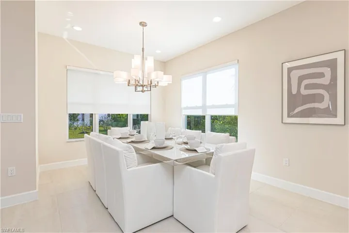 Tiled dining space featuring a notable chandelier