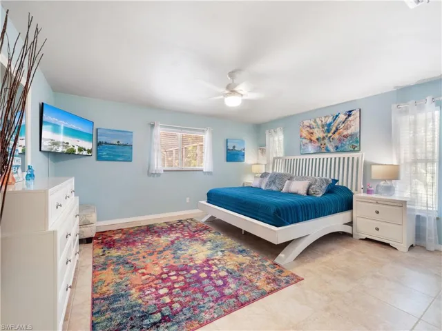 Bedroom featuring a ceiling fan and light tile patterned flooring