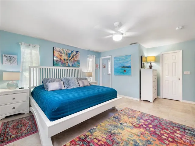 Bedroom with ceiling fan and baseboards