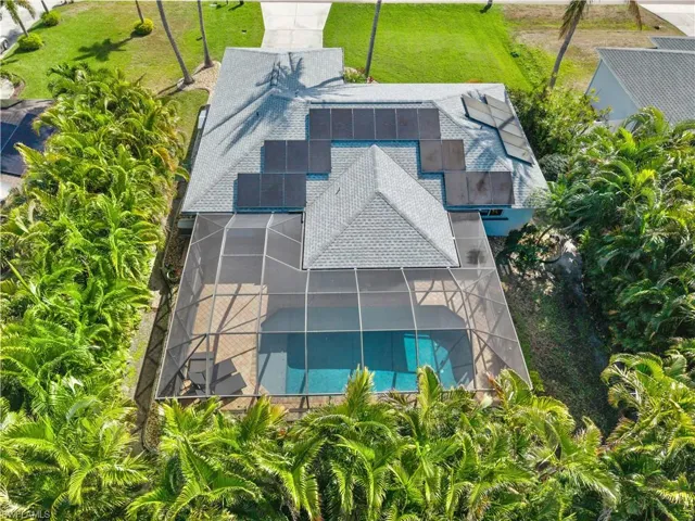 Aerial view of property and surrounding area featuring a pool
