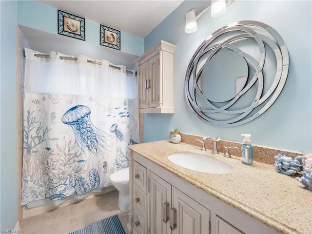 Full bathroom featuring vanity and light tile patterned floors