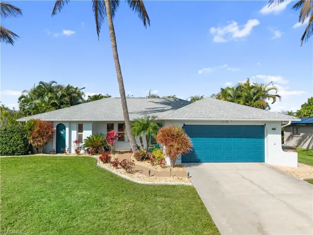 Ranch-style home with stucco siding, an attached garage, driveway, and a front lawn