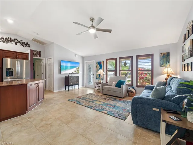 Living room featuring lofted ceiling and ceiling fan