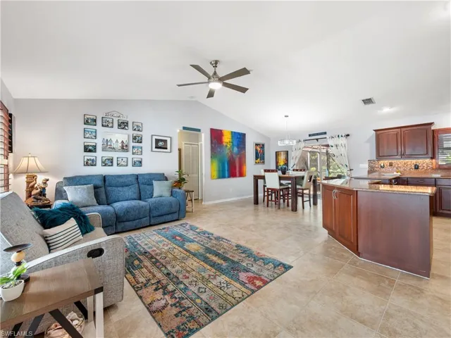 Living area featuring ceiling fan and baseboards