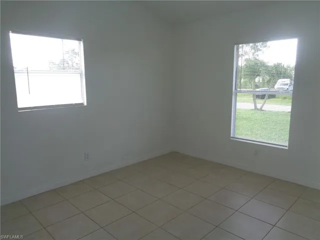Unfurnished bedroom 1 with light tile patterned floors