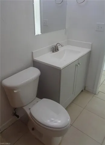 Bathroom with tile patterned floors and vanity