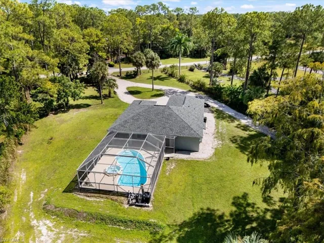 View of subject property featuring a pool area