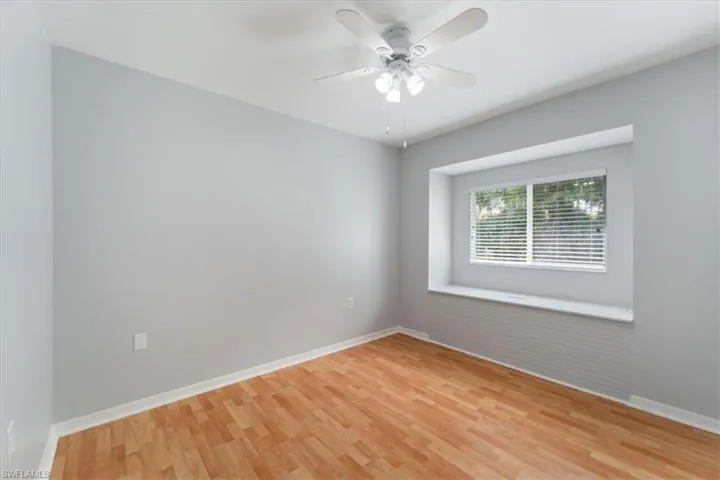 Empty room with light wood-type flooring and a ceiling fan