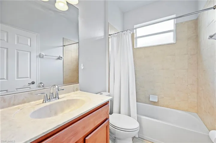 Full bathroom featuring vanity, toilet, and shower / tub combo