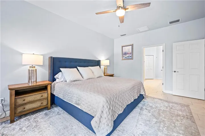 Bedroom featuring ceiling fan and light tile floors
