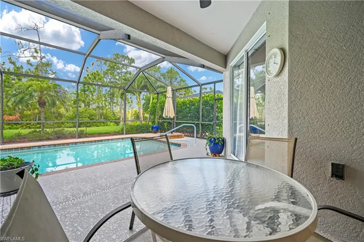 View of pool with a lanai and a patio area