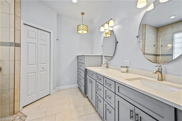 Bathroom featuring dual vanity and tile flooring