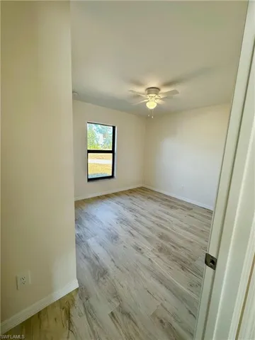 Spare room featuring light hardwood / wood-style floors and ceiling fan