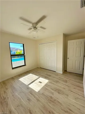 Unfurnished bedroom with a closet, ceiling fan, and light hardwood / wood-style floors