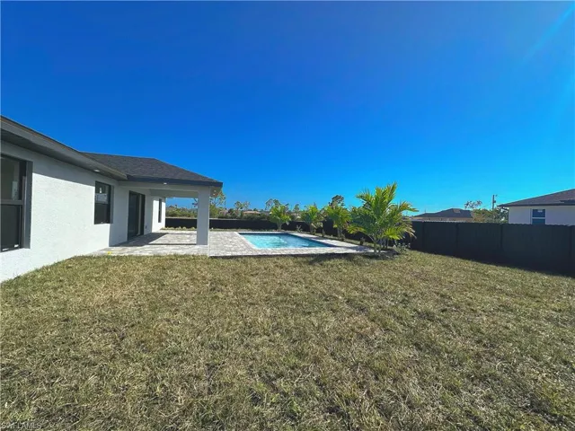 View of yard with a patio area and a fenced in pool