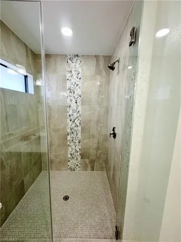 Bathroom featuring a shower with door