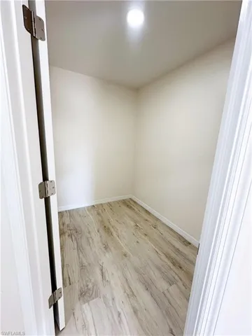 Empty room with light hardwood / wood-style flooring