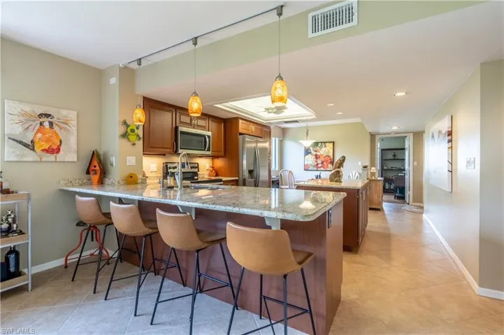 View of breakfast bar and into the kitchen from living room