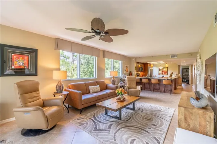 Tiled living room with tile on the diagonal and fashion ceiling fan