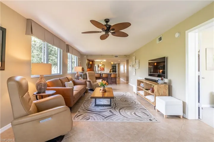Living room featuring light tile flooring and neutral color palette