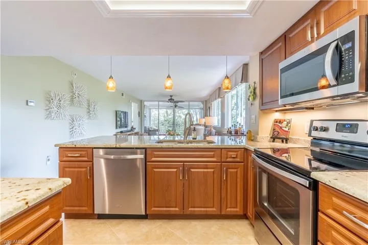 Kitchen featuring light counter tops, stainless steel appliances and tile flooring