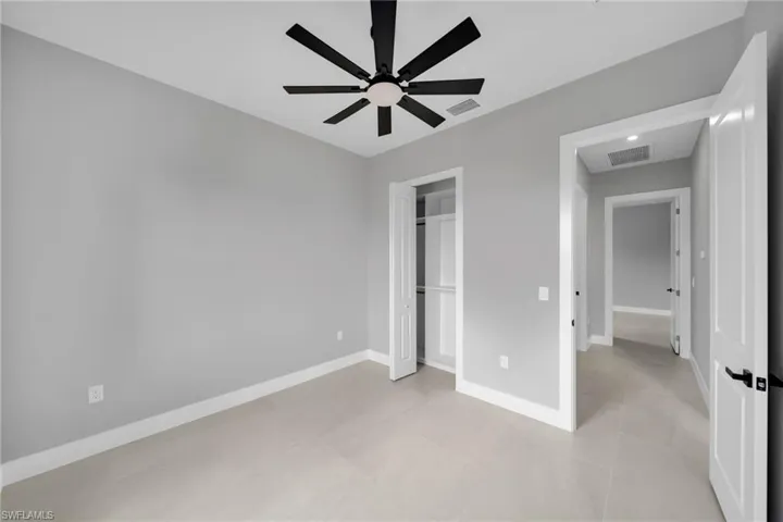 Unfurnished bedroom featuring a ceiling fan and a closet