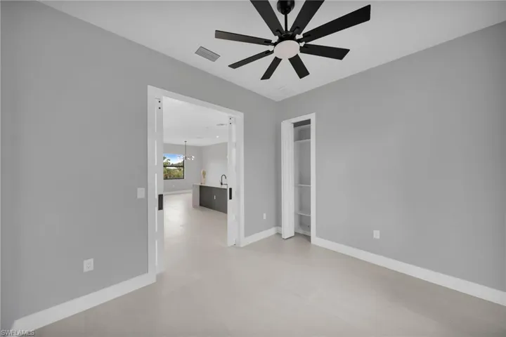 Unfurnished bedroom featuring ceiling fan and baseboards