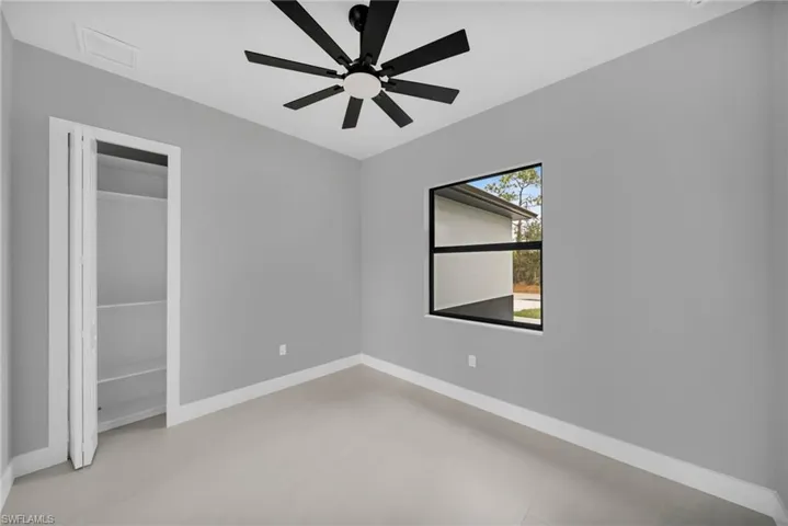 Unfurnished bedroom featuring a closet and a ceiling fan