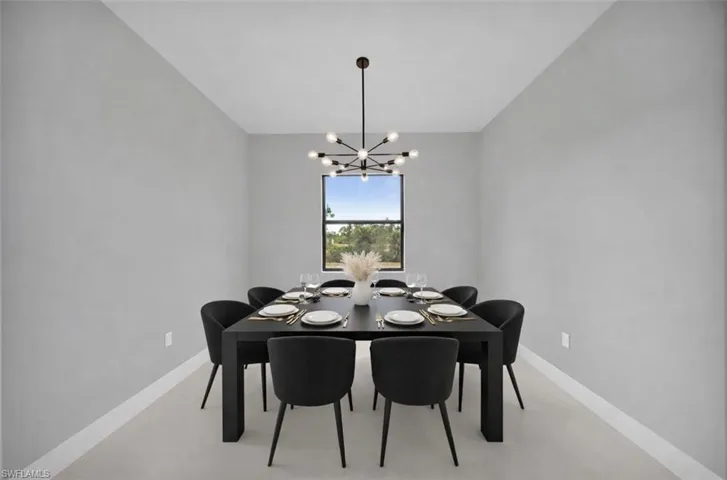 Dining room featuring baseboards and a chandelier