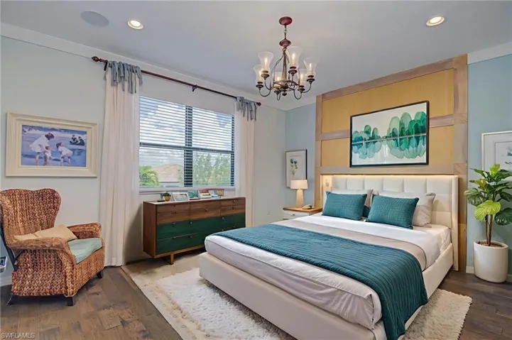 Bedroom featuring wood finished floors, a chandelier, and recessed lighting