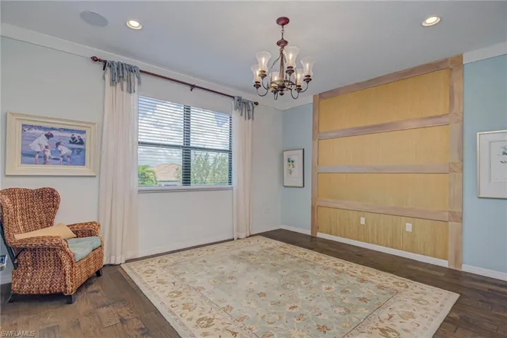 Sitting room with dark wood finished floors, a chandelier, and recessed lighting