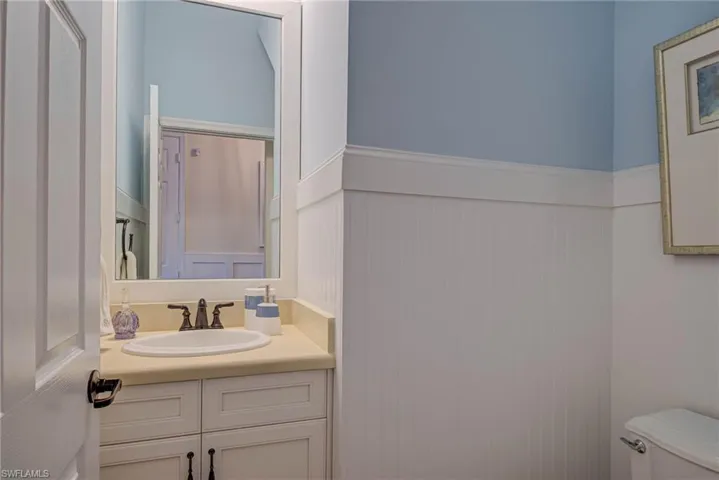 Bathroom featuring a wainscoted wall and vanity