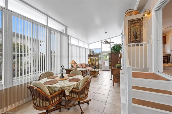 Sunroom / solarium featuring ceiling fan and lofted ceiling