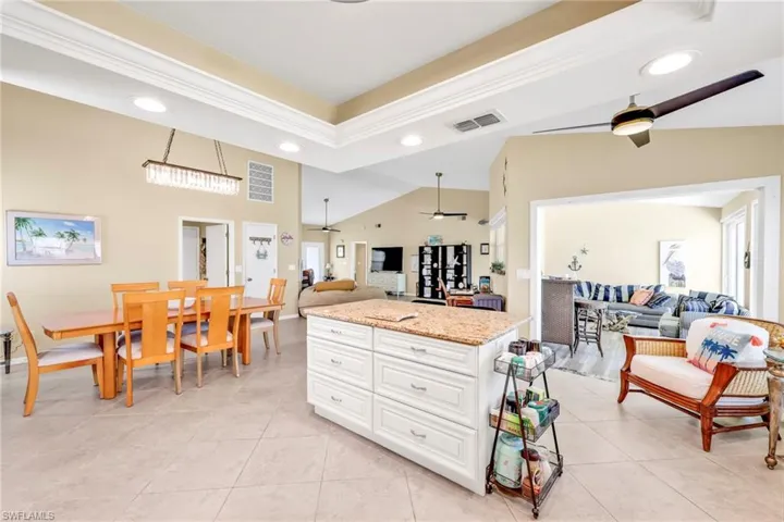Kitchen featuring a ceiling fan, open floor plan, visible vents, and recessed lighting